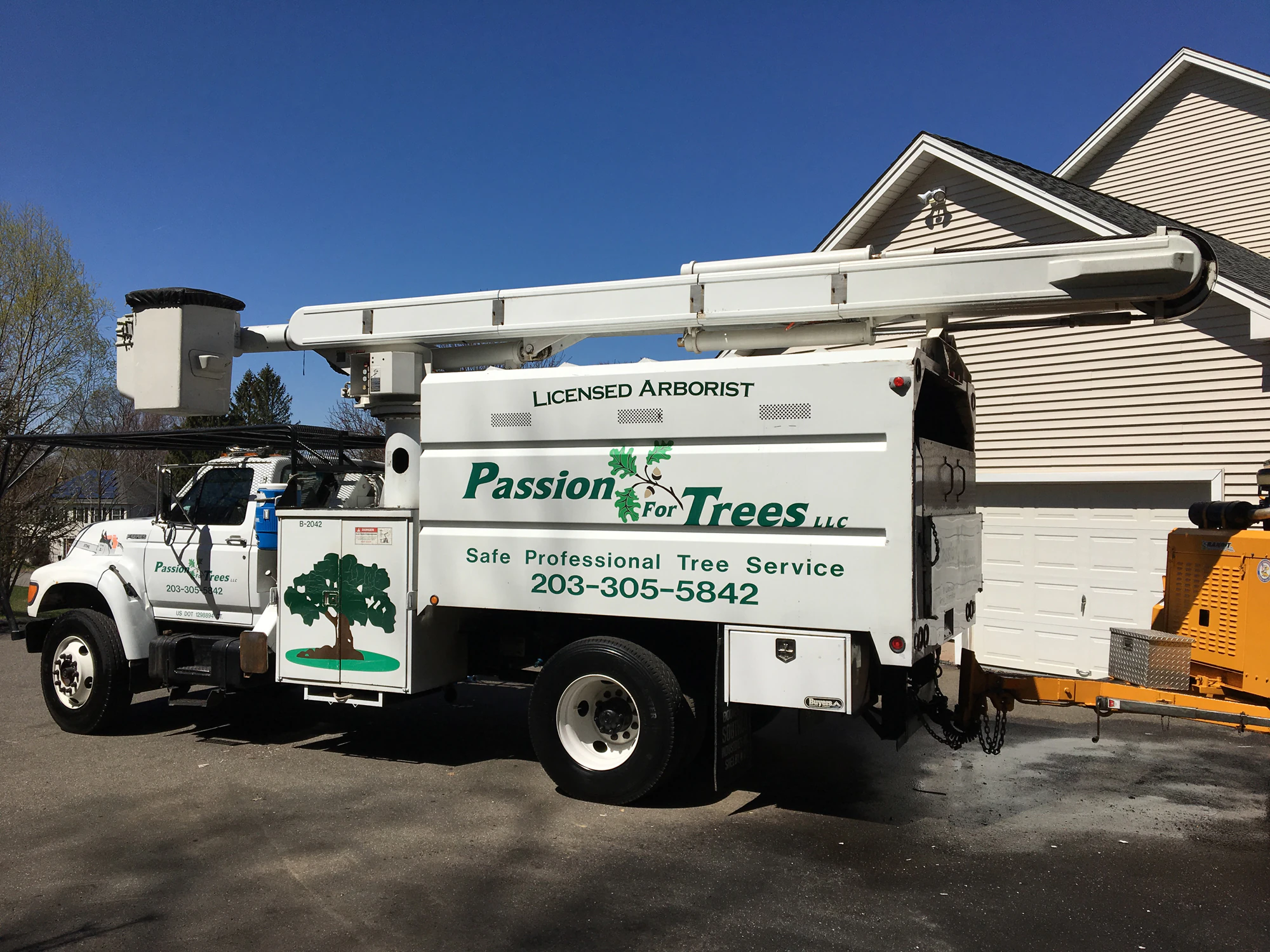 Passion For Trees bucket truck marked Licensed Arborist
